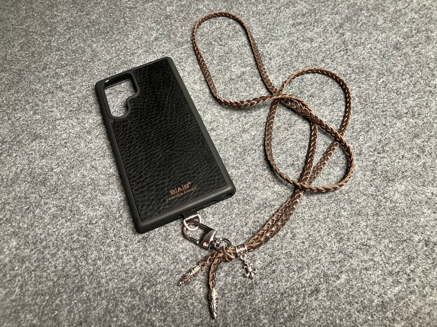 Capa/Suporte para Samsung de Couro Flor Integral/microfibra. 2 Terminais Espirais, 1 Pino em Espiral com Argola e 1 Pingente Fleur de Lys, todos de Prata 925 & Crossbody/Colar/Pulseira de Couro com 3 fios duplos trançados à mão, Marrom ou Preto.- KC45S