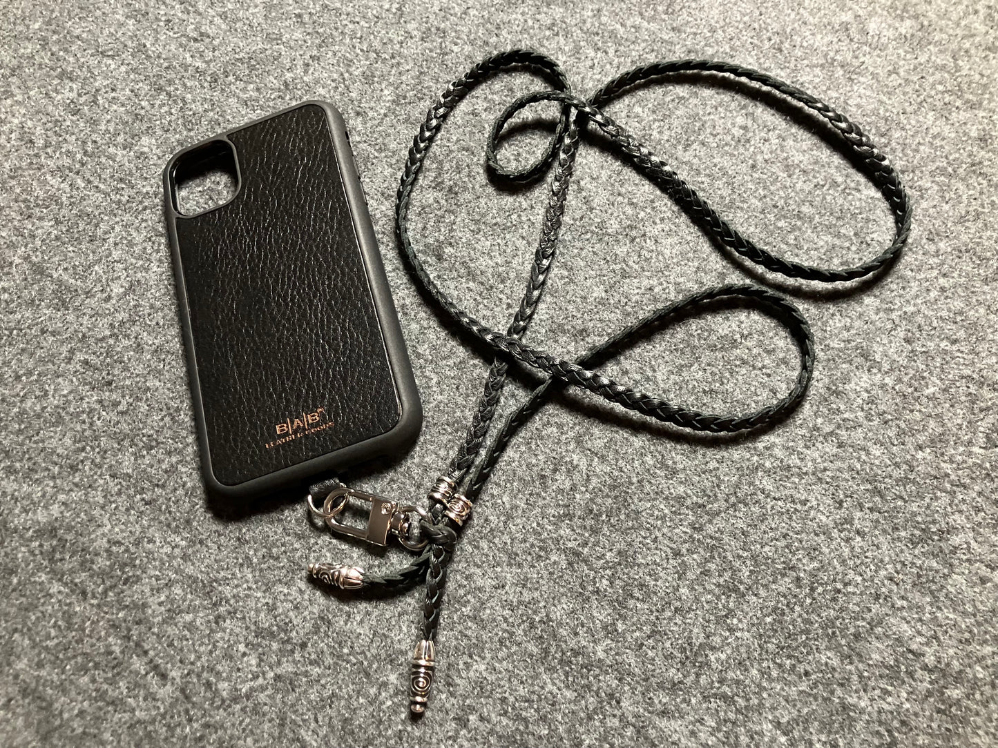 Capa/Suporte para iPhone de Couro Genuíno Flor Integral cortados e gravados a laser/microfibra. 2 Terminais Espirais e 2 Pinos Espirais, todos feitos de Prata 925 & Crossbody/Colar/Pulseira com três fios duplos trançados à mão, Marrom ou Preto.- KC43i