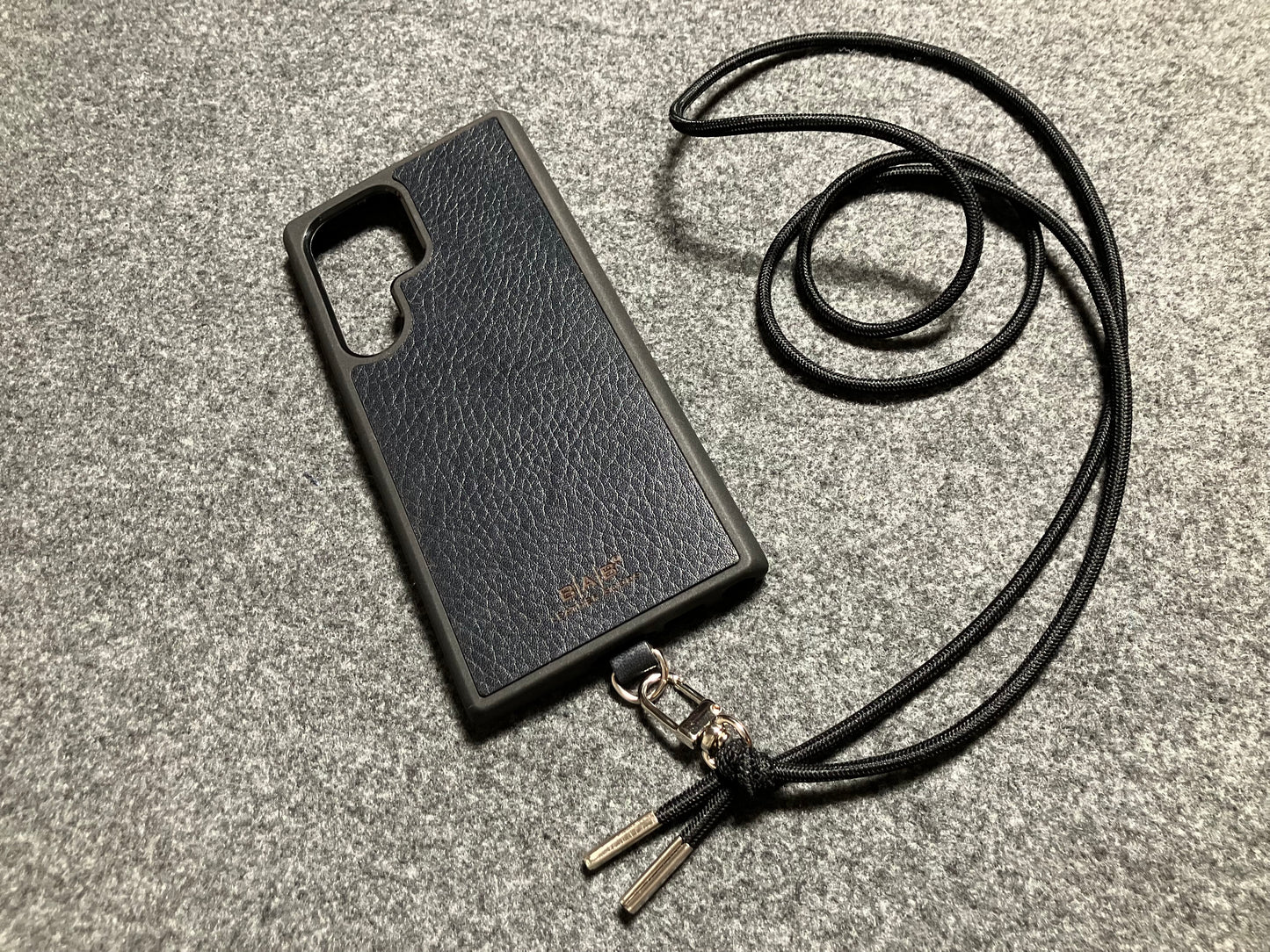 Samsung Case/Holder, Laser Cut & Engraved Full-Grain vegetable-tanned Genuine Leather/microfiber & Black Elastic Rope Crossbody/Necklace/Choker/Bracelet with a Carabiner, and 2 Silver End caps.- KCS53