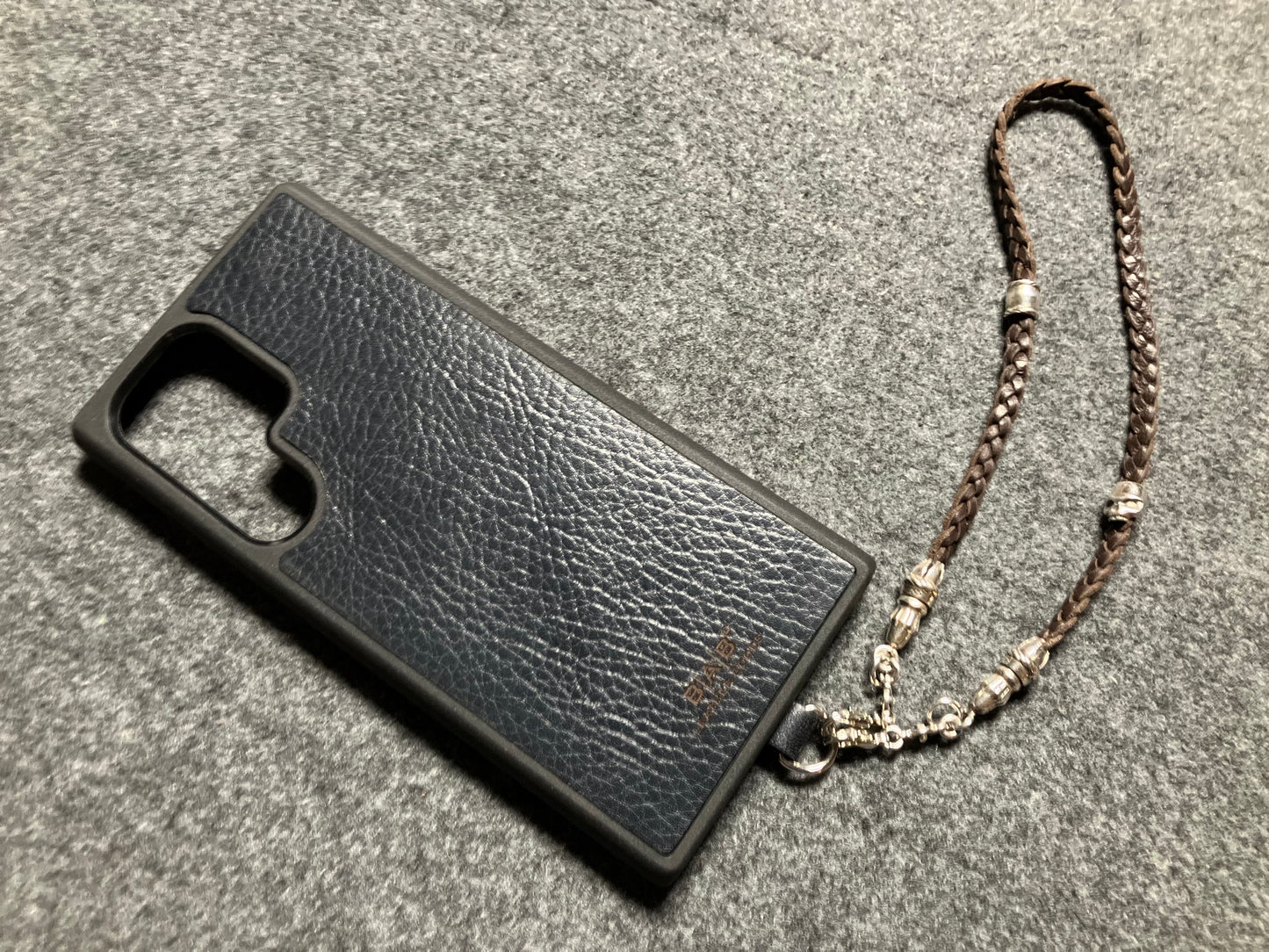 Full-Grain Genuine Leather Laser-cut & engraved Samsung Case/Holder/microfiber & 2 Terminals & 1 Rope Pin, 1 Skull, and 6 Rings, all made of 925 Sterling Silver & Strap/Choker/Bracelet, hand-braided 3-strands Leather, Brown or Black.- KP03S