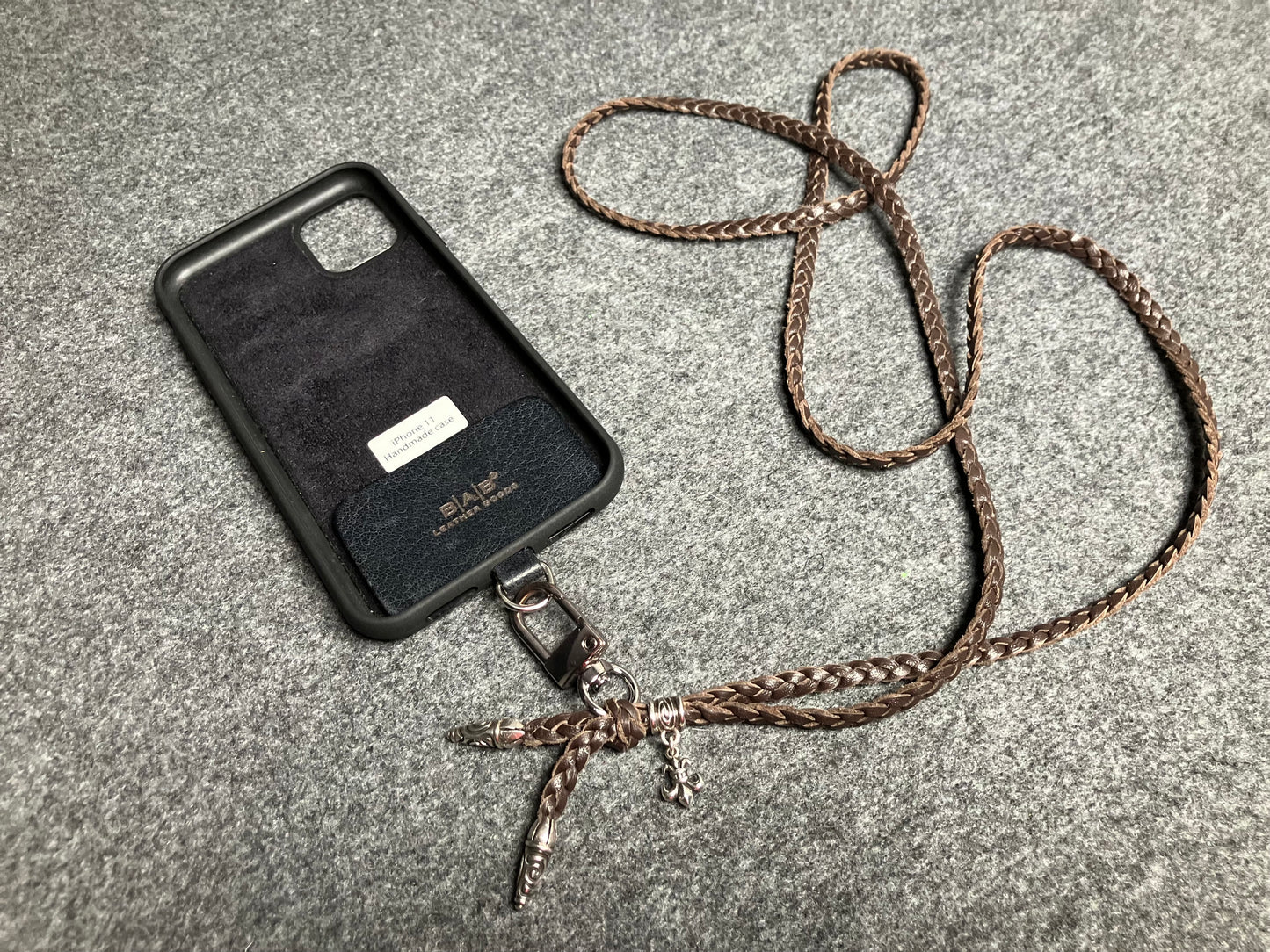 Capa/Suporte para iPhone de Couro Flor Integral/microfibra. 2 Terminais Espirais, 1 Pino em Espiral com Argola e 1 Pingente Fleur de Lys, todos de Prata 925 & Crossbody/Colar/Pulseira de Couro com 3 fios duplos trançados à mão, Marrom ou Preto.- KC45i