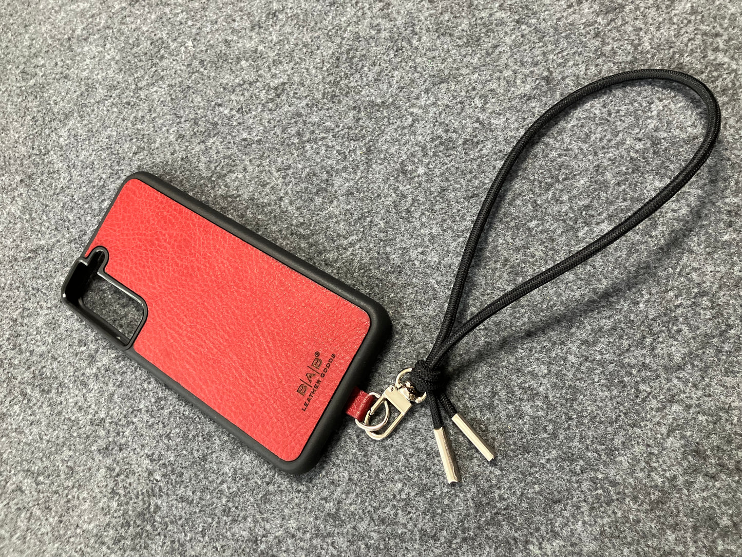 Laser-engraved Full-Grain vegetable-tanned Genuine Leather cell phone Holder & Black Elastic Rope Strap/Bracelet with a Carabiner, and 2 Silver End caps.- SP56