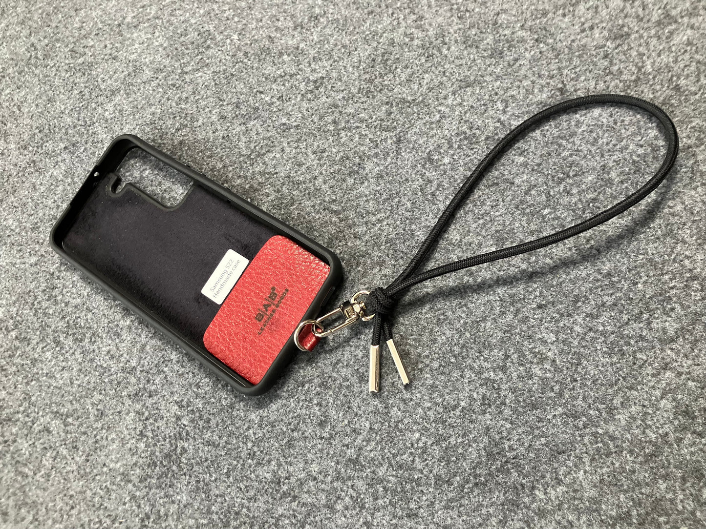 Laser-engraved Full-Grain vegetable-tanned Genuine Leather cell phone Holder & Black Elastic Rope Strap/Bracelet with a Carabiner, and 2 Silver End caps.- SP56