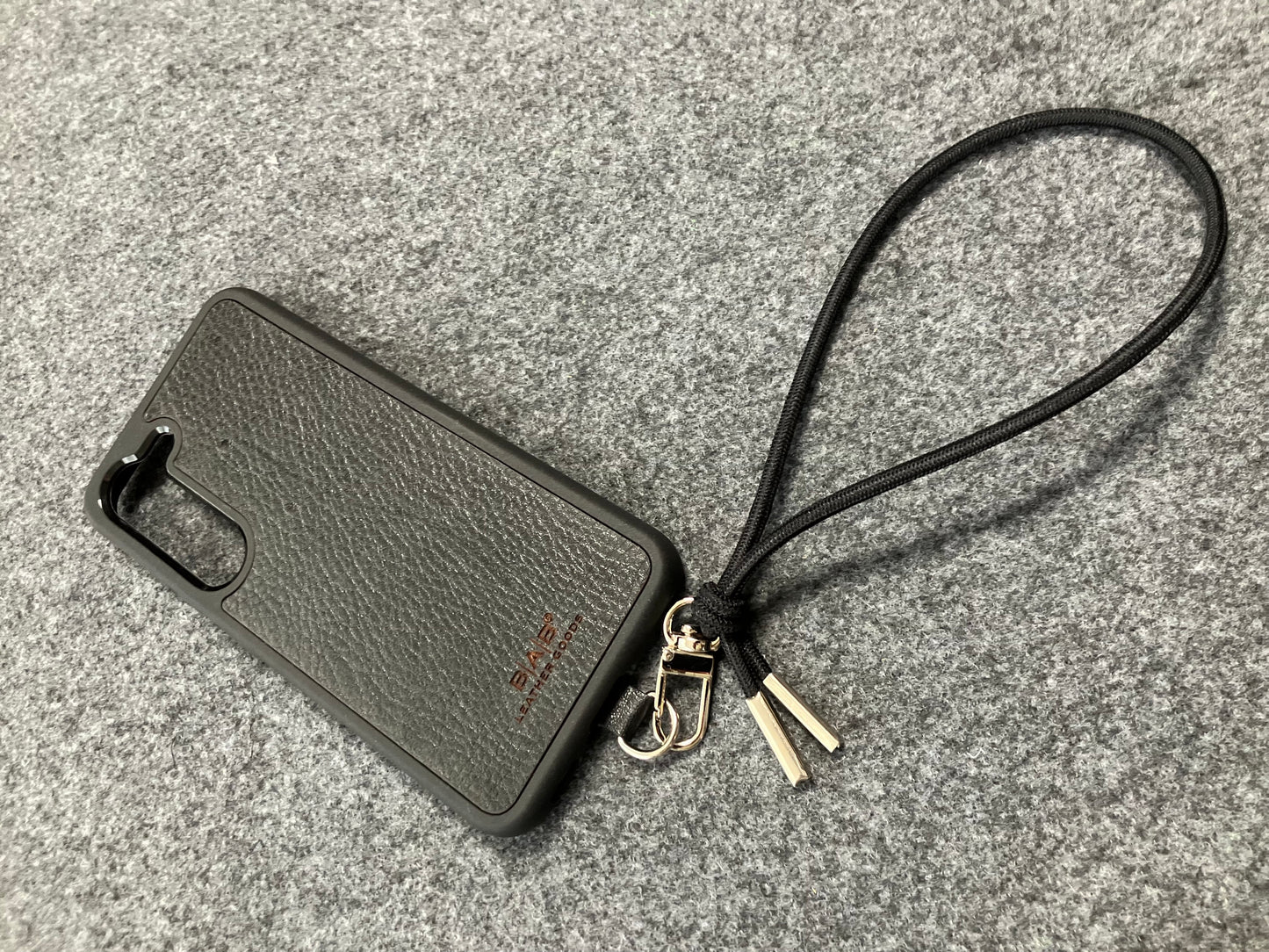 Laser-engraved Full-Grain vegetable-tanned Genuine Leather cell phone Holder & Black Elastic Rope Strap/Bracelet with a Carabiner, and 2 Silver End caps.- SP56