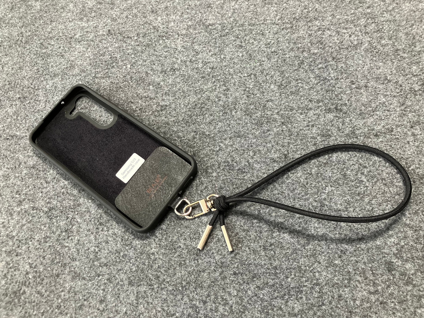 Laser-engraved Full-Grain vegetable-tanned Genuine Leather cell phone Holder & Black Elastic Rope Strap/Bracelet with a Carabiner, and 2 Silver End caps.- SP56