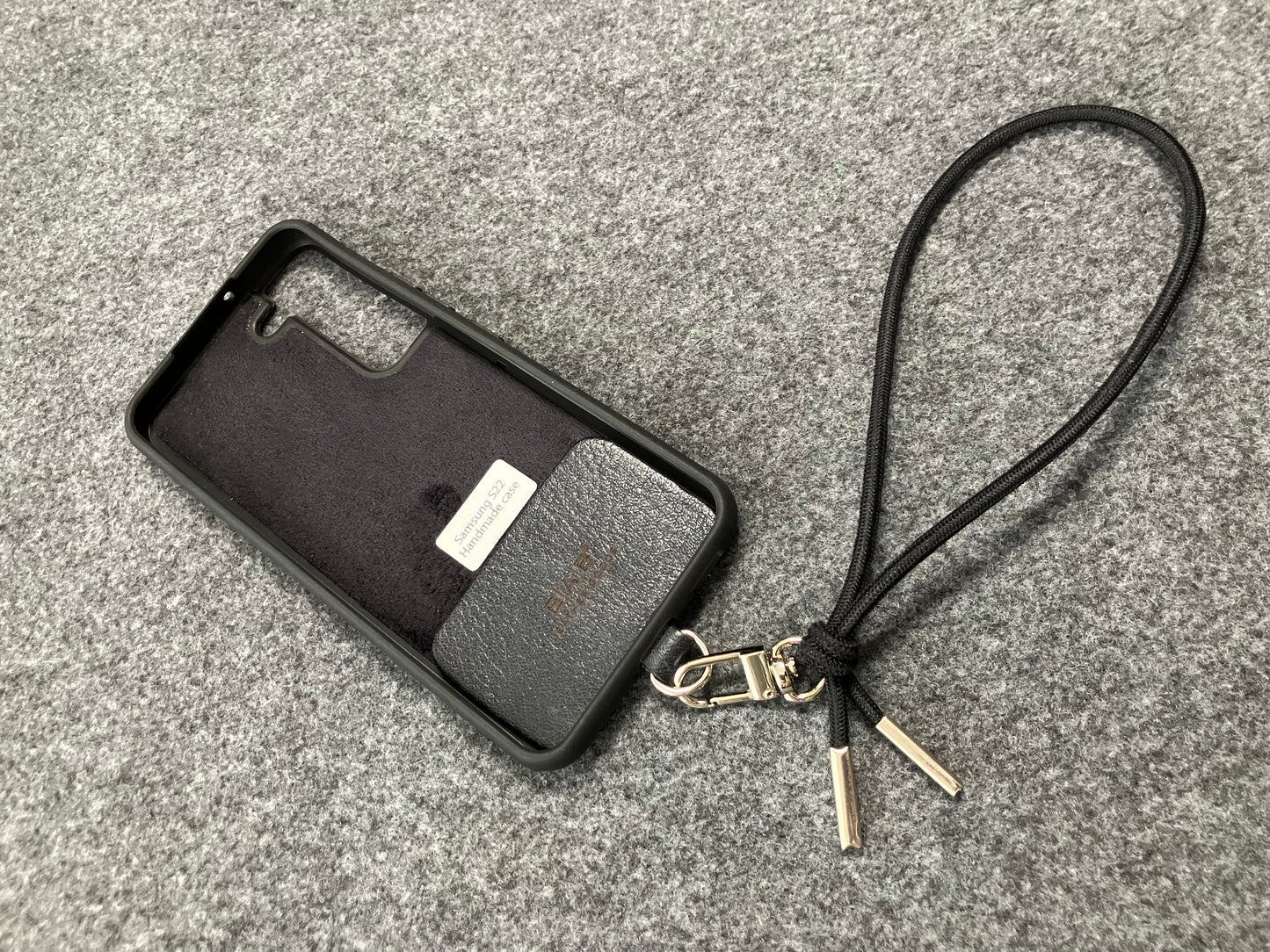 Laser-engraved Full-Grain vegetable-tanned Genuine Leather cell phone Holder & Black Elastic Rope Strap/Bracelet with a Carabiner, and 2 Silver End caps.- SP56