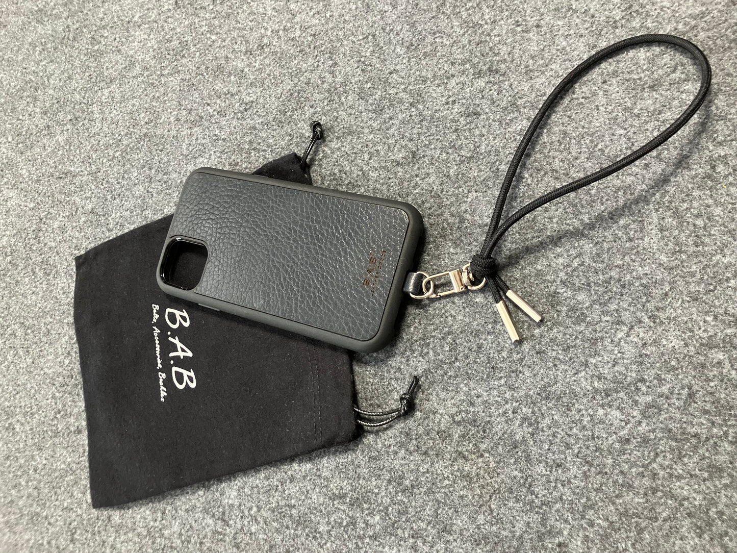 Laser-engraved Full-Grain vegetable-tanned Genuine Leather cell phone Holder & Black Elastic Rope Strap/Bracelet with a Carabiner, and 2 Silver End caps.- SP56