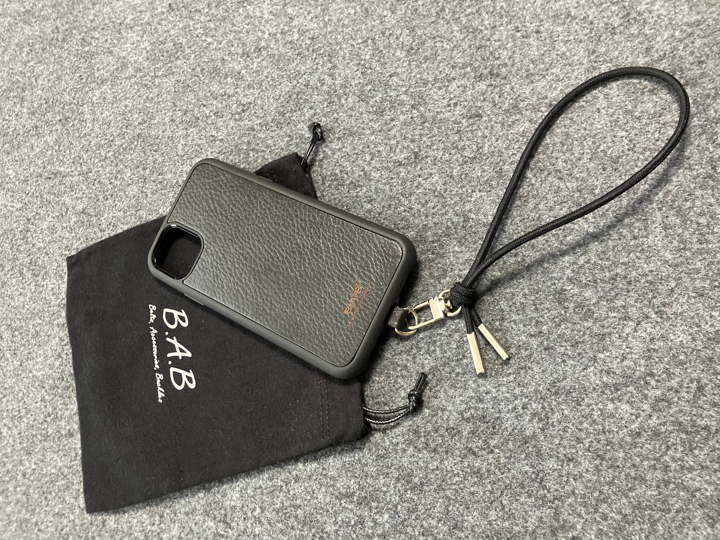 Laser-engraved Full-Grain vegetable-tanned Genuine Leather cell phone Holder & Black Elastic Rope Strap/Bracelet with a Carabiner, and 2 Silver End caps.- SP56